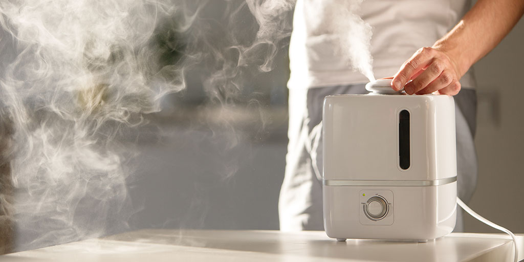 Man turning on a humidifier.